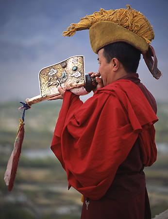 Tikse Ladakh: monk Announcing the morning Puja morning prayers for the monks fine art travel photography copyright 2004 Brad Carlile